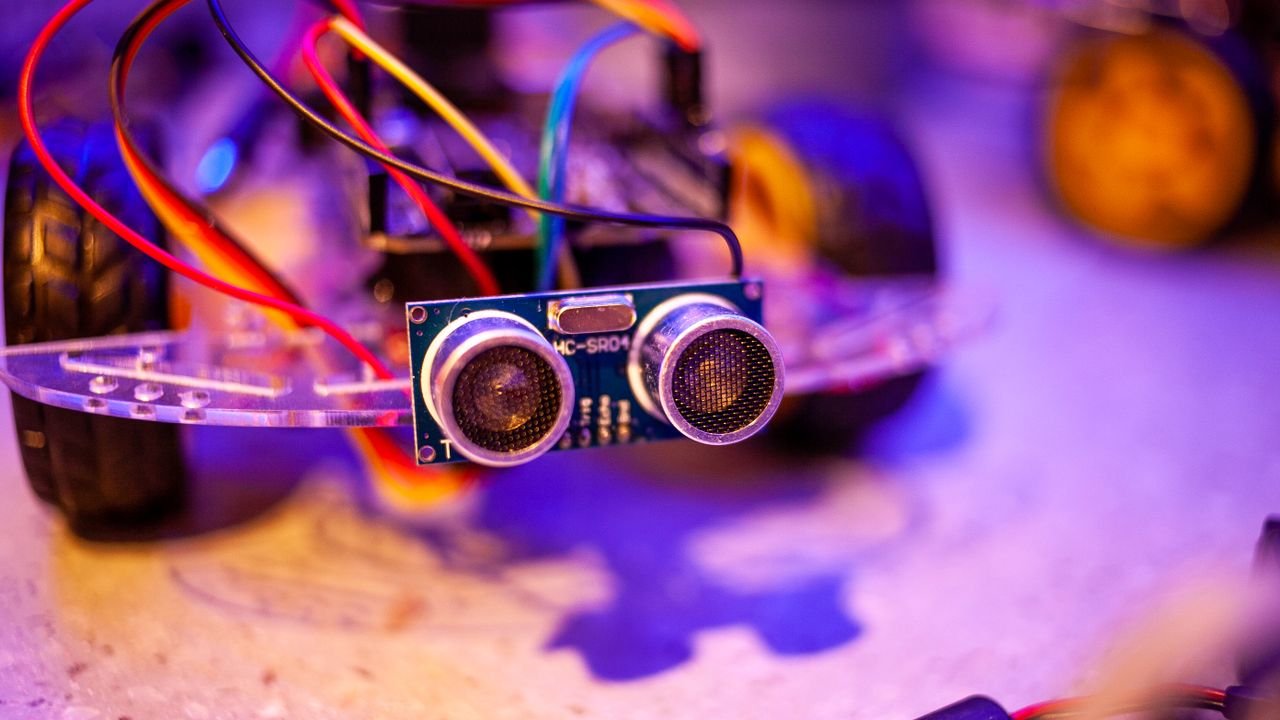 Detailed view of a robotic vehicle component showcasing wires and sensors.