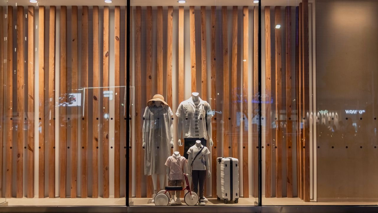 Elegant storefront display with mannequins in fashionable attire, seen in Wuhan, China.