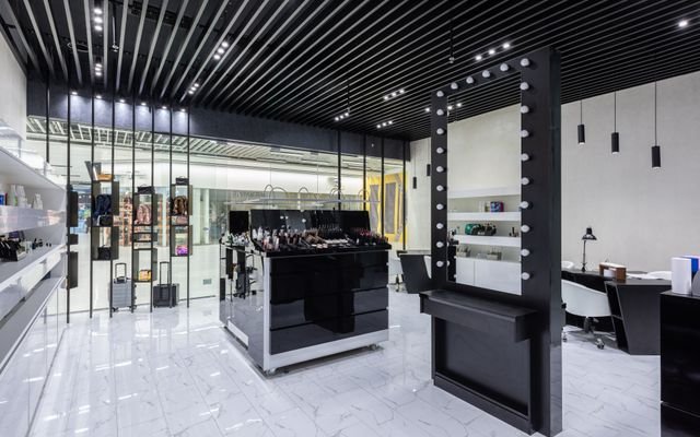 Highly stylized contemporary makeup store with elegant furnishings and lighting.