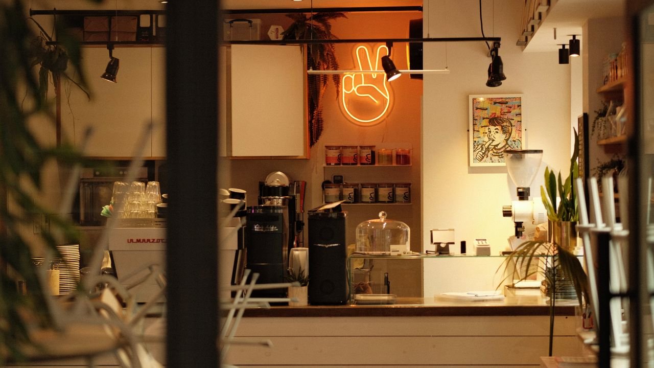 Warm ambiance in a modern café with stylish neon peace sign lighting.