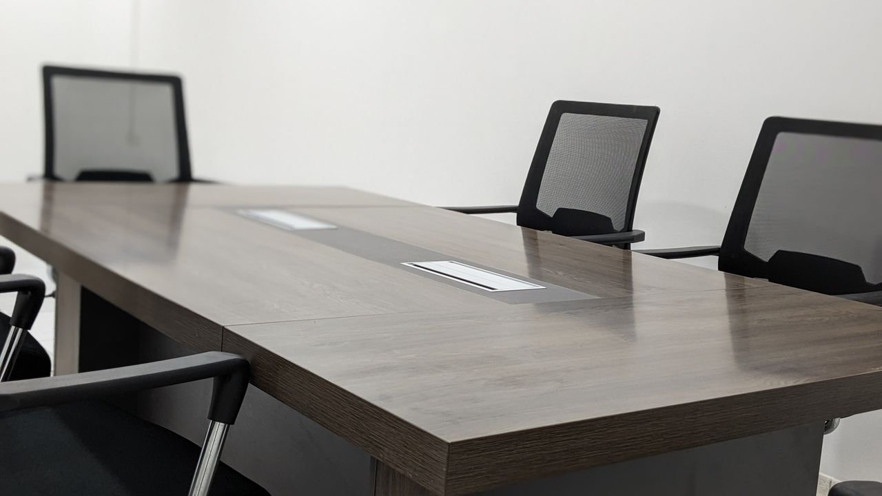 Sleek and empty conference room with modern furniture and minimalist design.