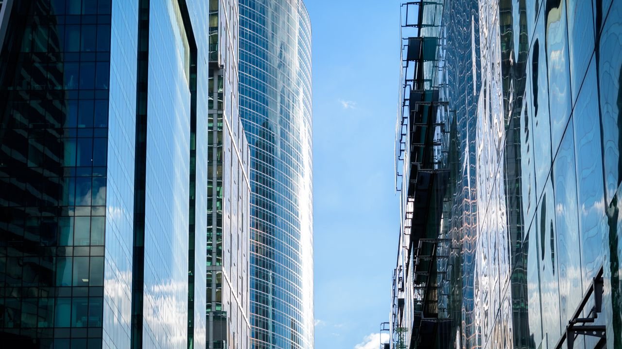 Contemporary skyscrapers reflecting the sky, showcasing modern architectural design.