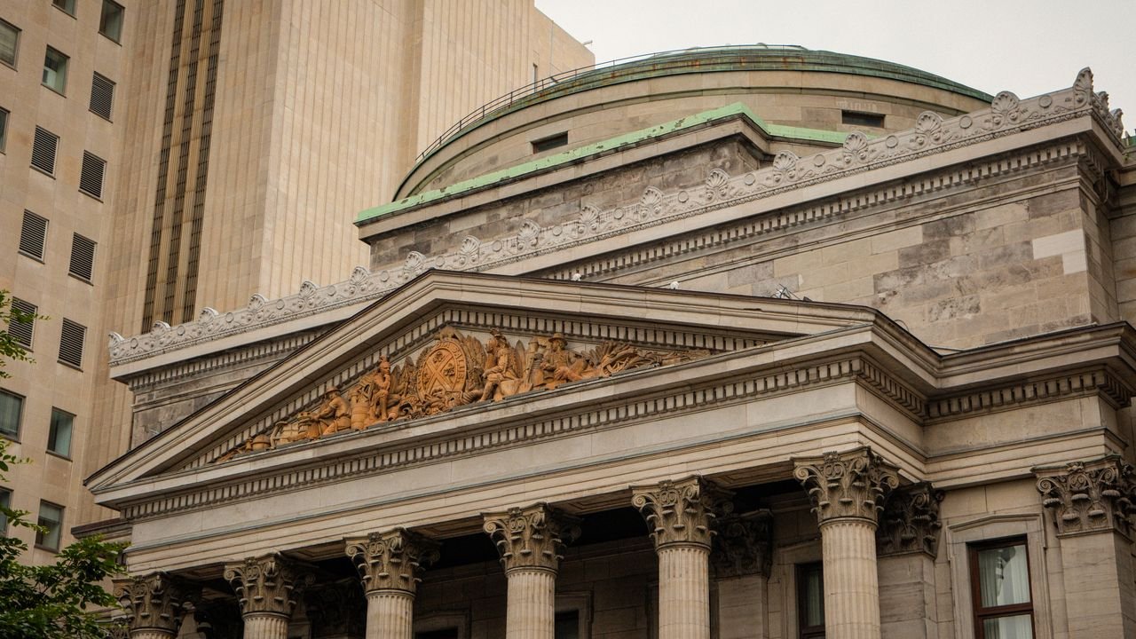 A detailed view of a historic Neo-Classical building facade in downtown Montreal.