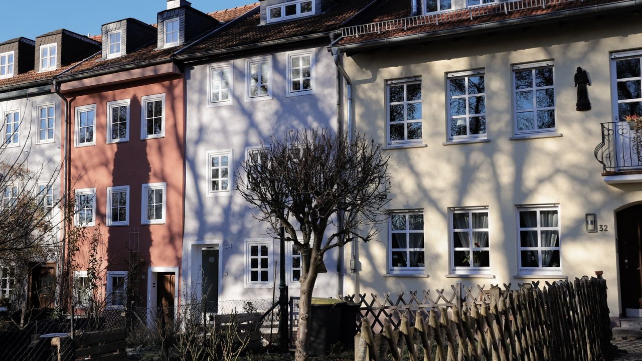 Colorful row houses in Fulda, Germany with shadows casting on a sunny day.