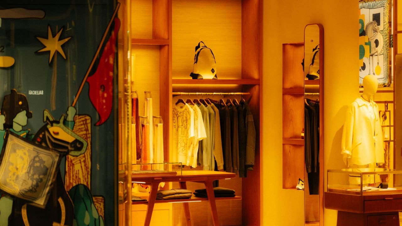 Elegant fashion boutique interior with stylish clothing and accessories on display.