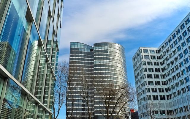 A striking view of modern skyscrapers against a clear blue sky, showcasing contemporary architectural design.