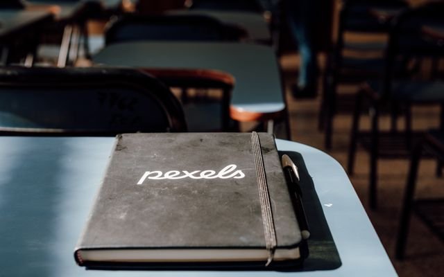 A close-up of a notebook and pen in a classroom setting in Buenos Aires, Argentina.