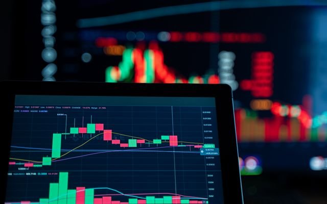 Close-up view of digital trading chart screen with vibrant graphs and data analysis.
