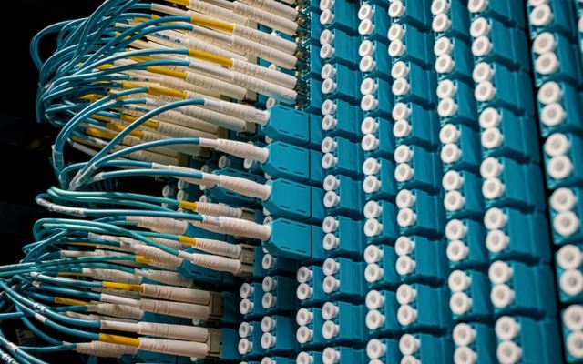 From below of fiber optic equipment with similar colorful rubber cables and round sockets