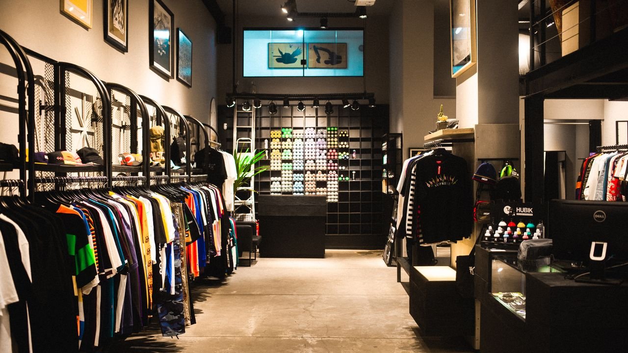 Explore the stylish interior of a modern urban fashion store with vibrant clothing displays.