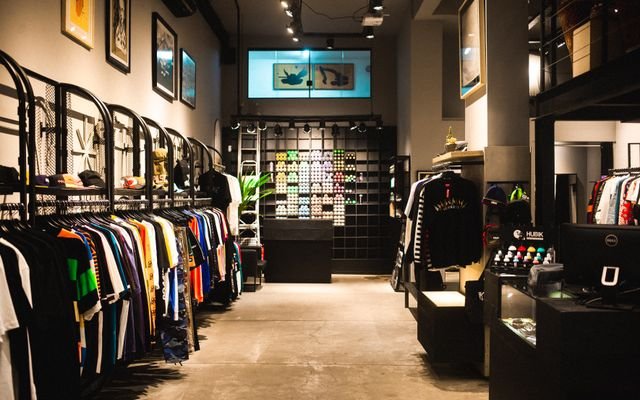 Explore the stylish interior of a modern urban fashion store with vibrant clothing displays.