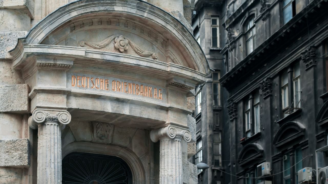 Deutsche orient bank in historical building with engraved elements and concrete columns on street near residential house in city of Istanbul