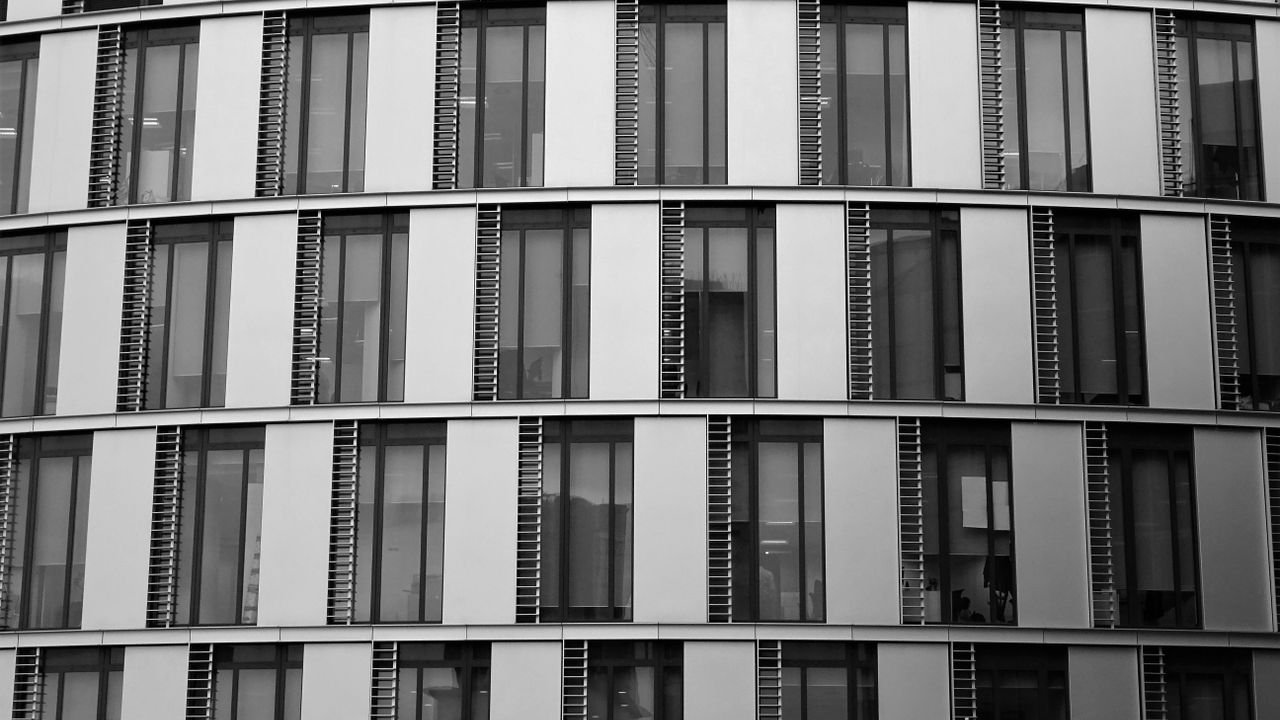 Close-up view of a contemporary office building exterior with glass and steel elements.